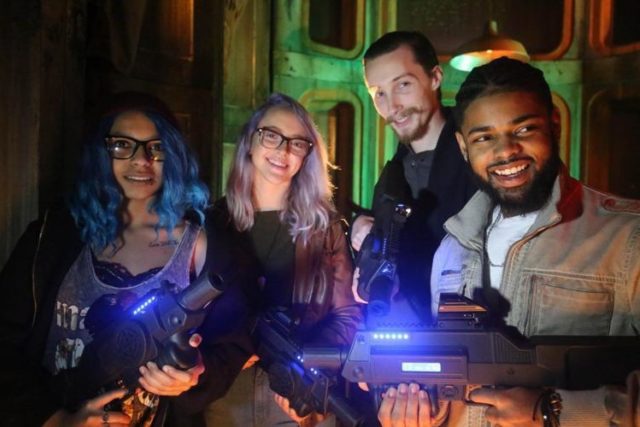 Adults playing laser tag