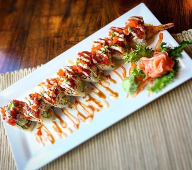 white plate of sushi on a table